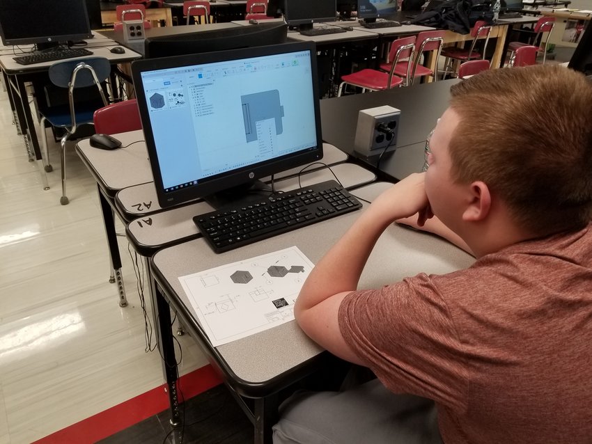 Layden Talmadge learns how to use an Autodesk Fusion 360 computer program.